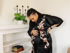 A pregnant woman holding her belly