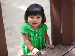 child in a green polka dot dress